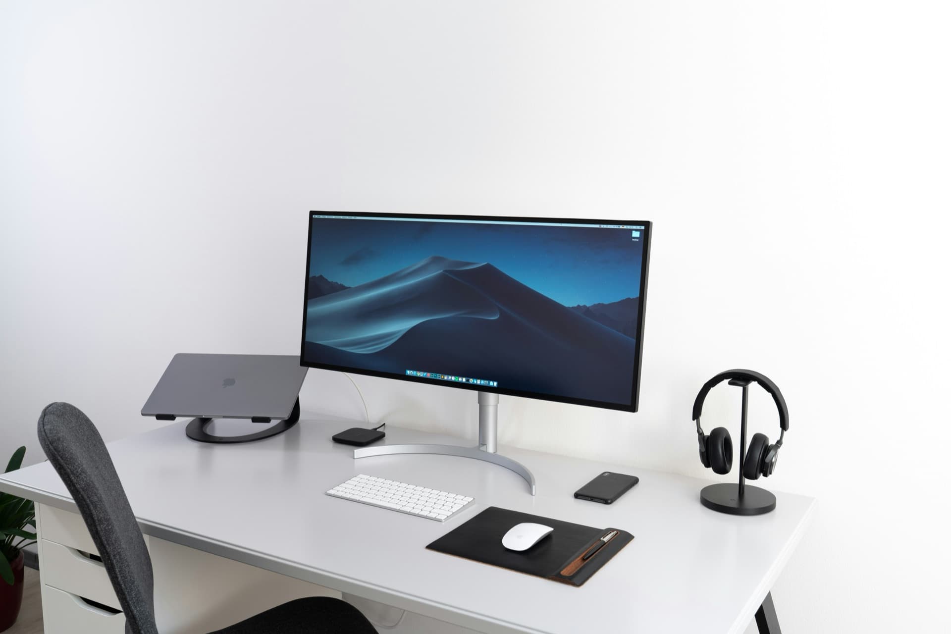 A clean, minimal desk with a single monitor, keyboard and tidy workspace